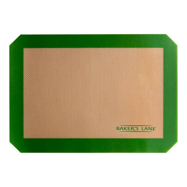 A tan rectangular Baker's Lane silicone baking mat with a green border.