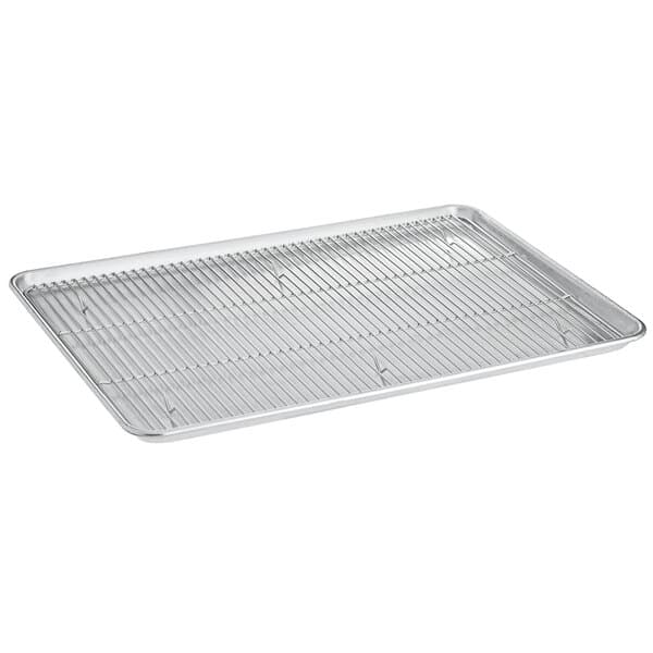 A Baker's Mark stainless steel footed wire cooling rack on a table over a full size baking sheet.