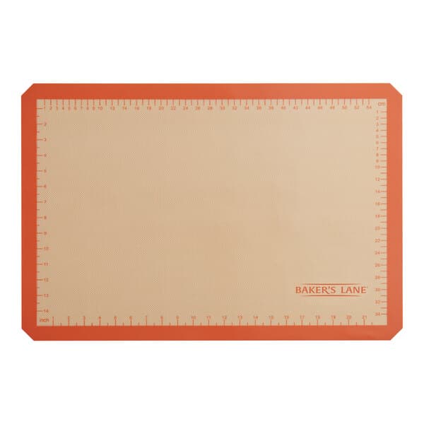 A Baker's Lane orange silicone baking mat with a red border and indexing.