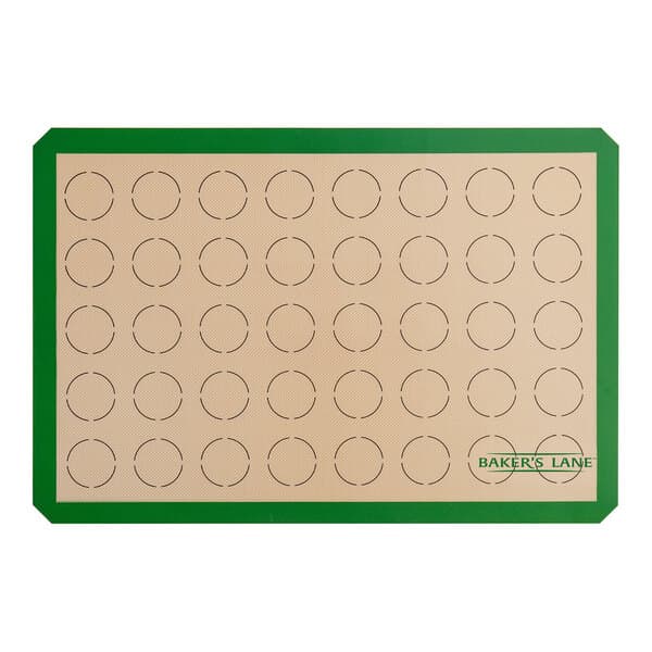 A green and white Baker's Lane baking mat with circles for 2" macarons.
