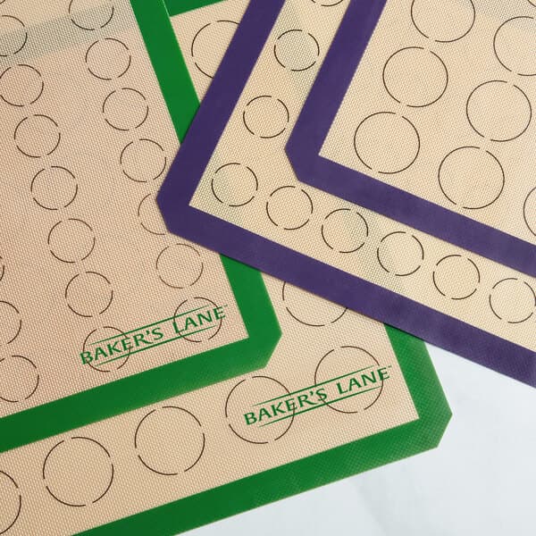 A Baker's Lane green silicone mat with circles for 64 macarons.