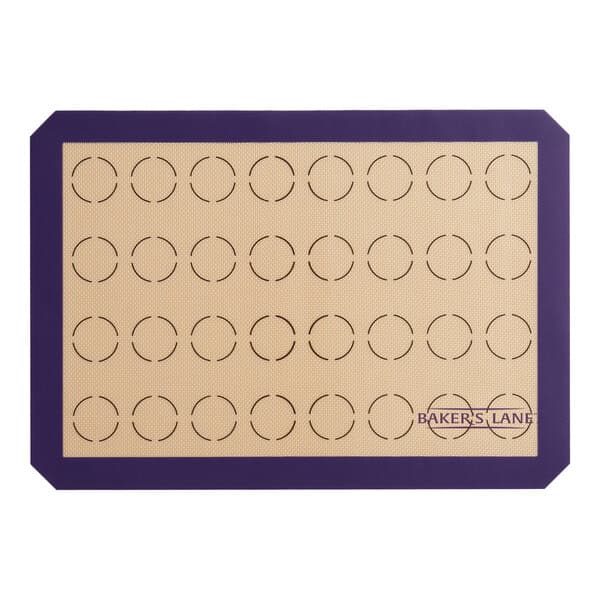 A Baker's Lane purple silicone baking mat with circles for 32 macarons.