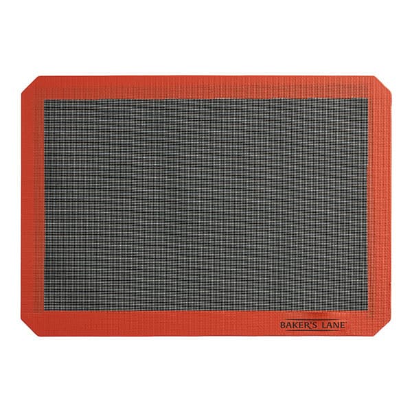 A white and orange Baker's Lane half size silicone baking mat with a black grid.