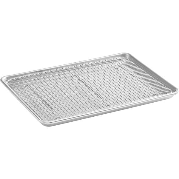 A Baker's Mark wire in rim aluminum sheet pan with stainless steel cooling rack on a counter.