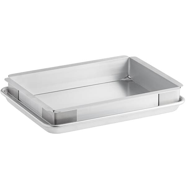 A silver rectangular Baker's Mark extender and sheet cake pan set.