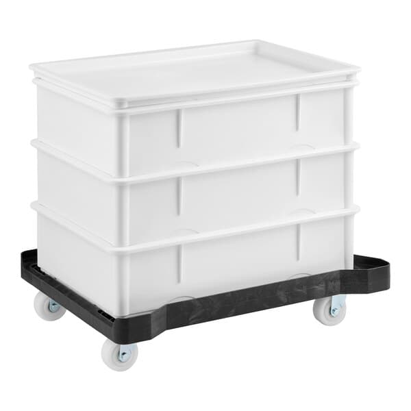 A set of three white dough proofing boxes with a plastic dolly for easy transport.