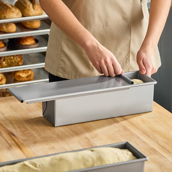 A glazed aluminized steel Pullman bread loaf pan with a sliding cover, measuring 13 x 4 x 4 inches.