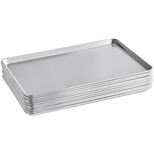 A stack of six Baker's Mark aluminum bun/sheet pans.