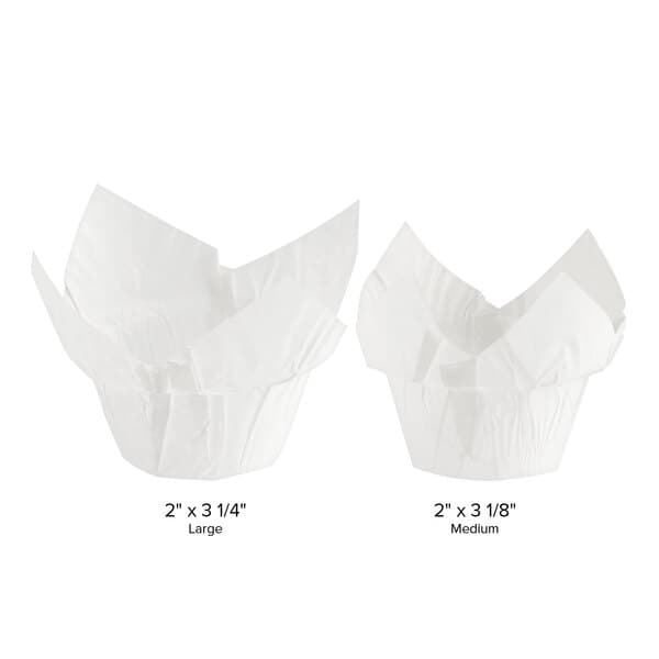 Two white Baker's Mark paper cupcake liners with a size comparison.