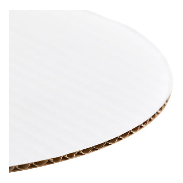 A round, white corrugated cardboard cake circle.