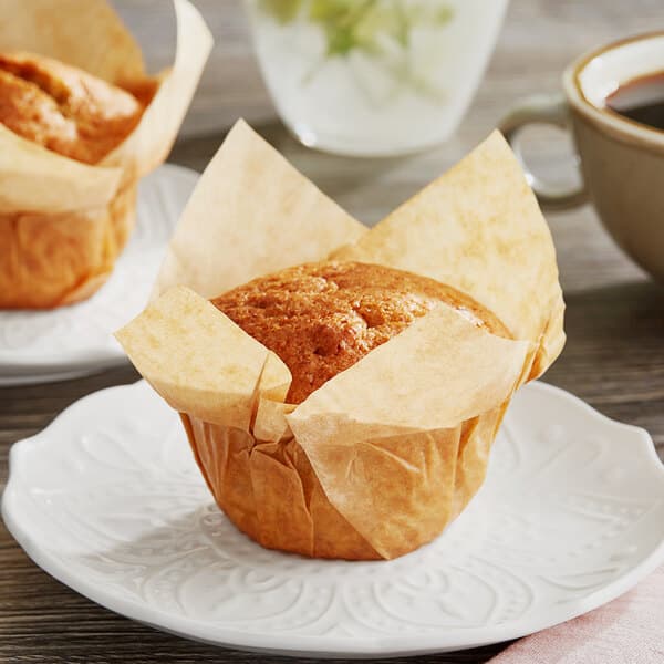 Two Baker's Mark unbleached natural kraft muffins on a plate.