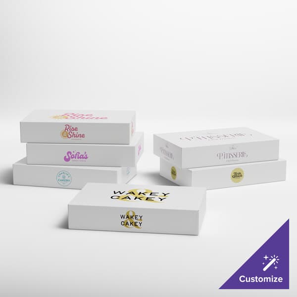 A group of white Baker's Lane boxes with different designs.
