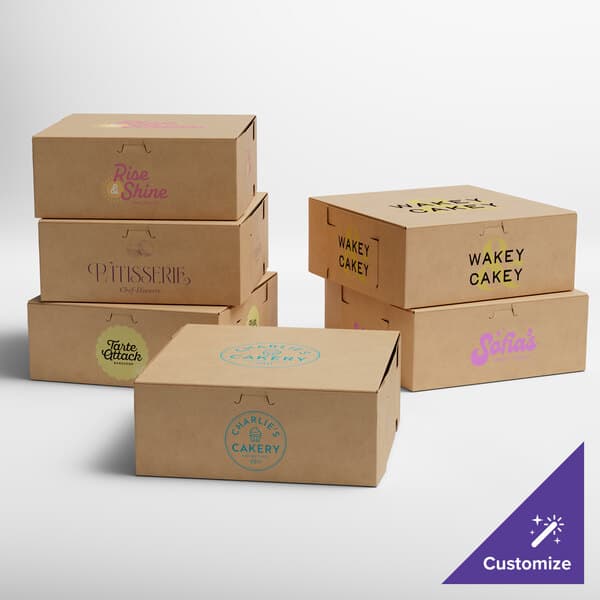 A set of customizable kraft cake and bakery boxes with various printed logos and designs.